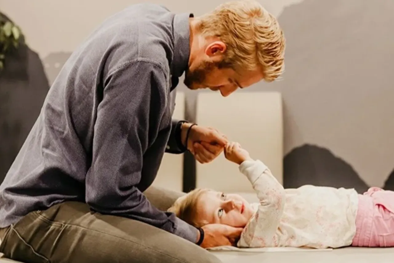 Dr. Josh Madsen adjusting a child