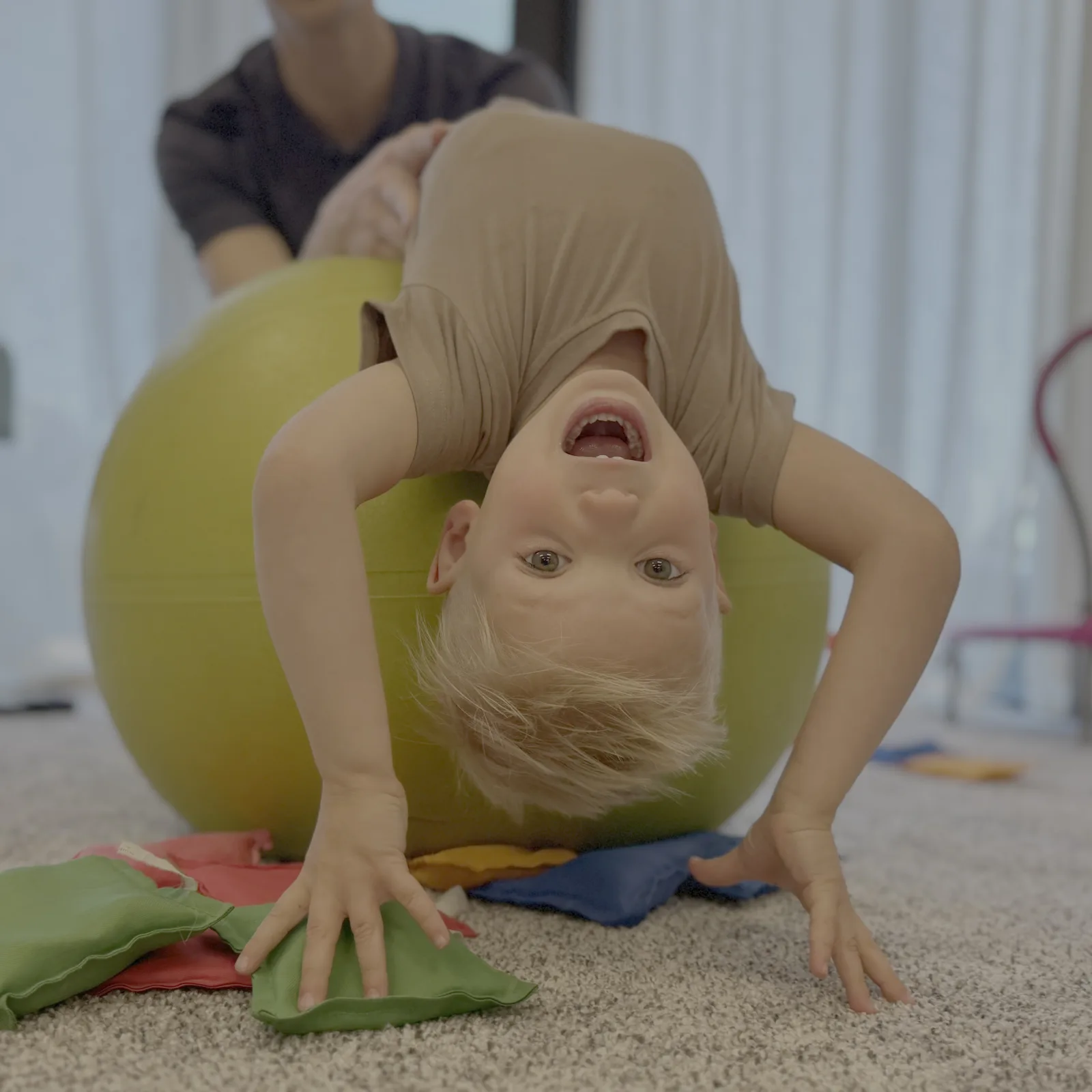 A parent and child working through home neurodevelopmental exercises